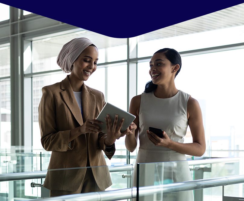 Graphic of two women talking and smiling with a tablet and cell phone in their hands