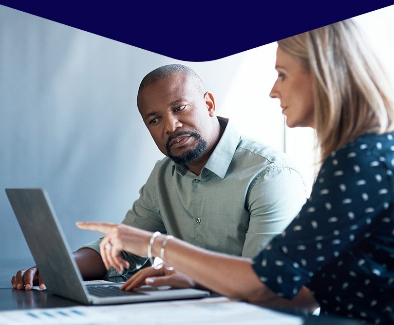 Man and a woman discussing business with a laptop